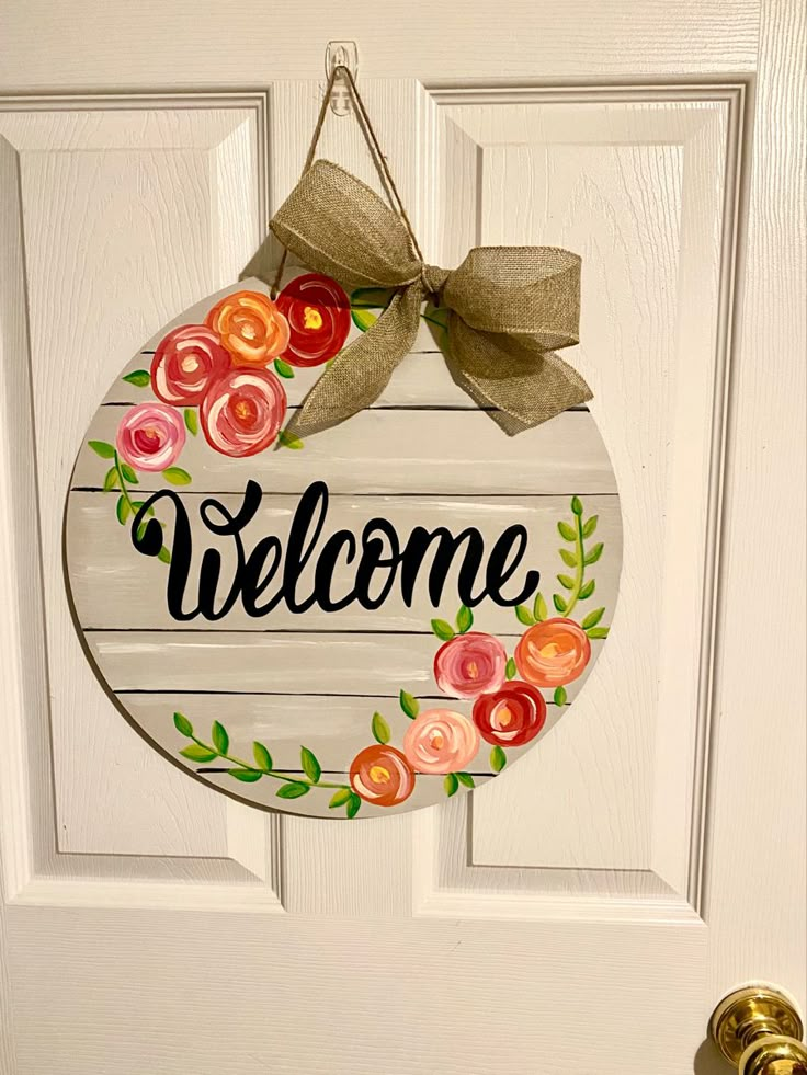 a welcome sign hanging on the front door