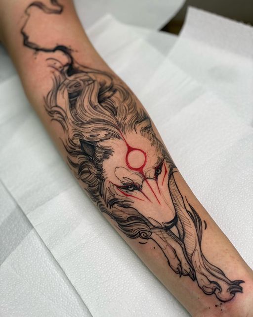 a person with a tattoo on their arm that has a clown face and red eyes