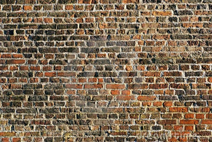 an old brick wall that has been painted red