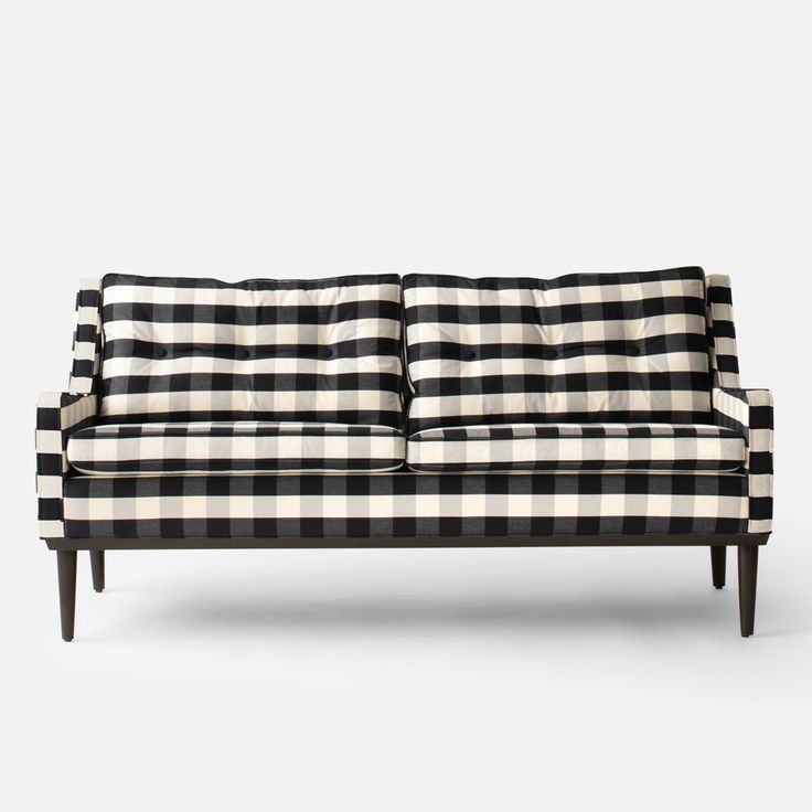 a black and white checkered couch sitting on top of a wooden table