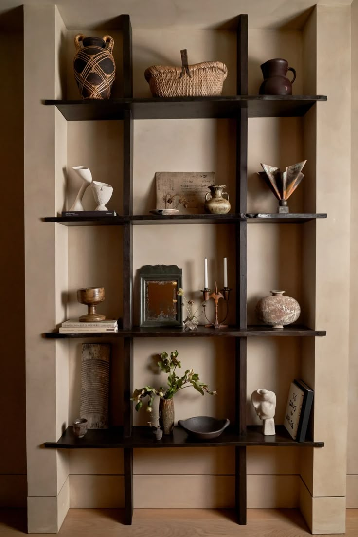 an empty shelf with vases and other items on it