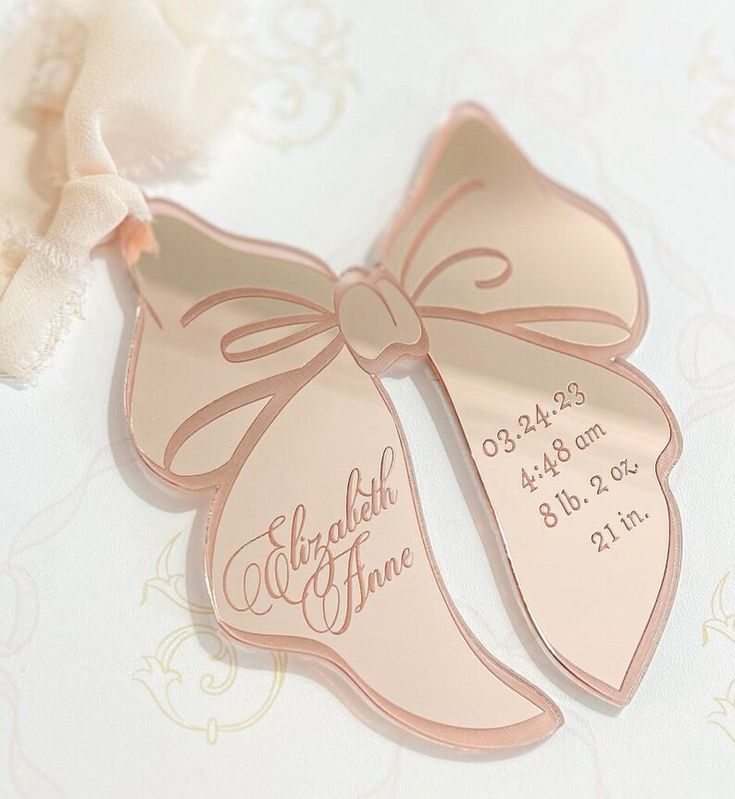 a close up of two wedding tags on a table