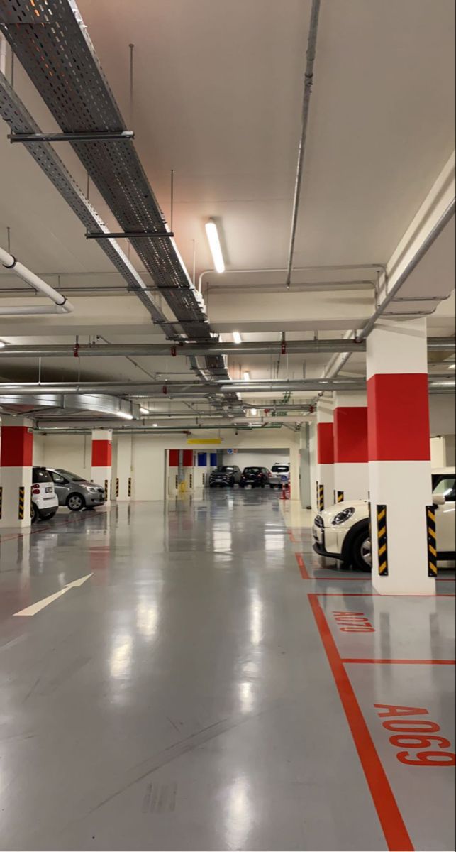 an empty parking garage with cars parked in it