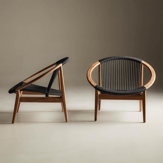 two chairs sitting next to each other on a white floor