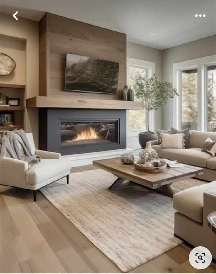 a living room filled with furniture and a flat screen tv mounted on the wall next to a fire place