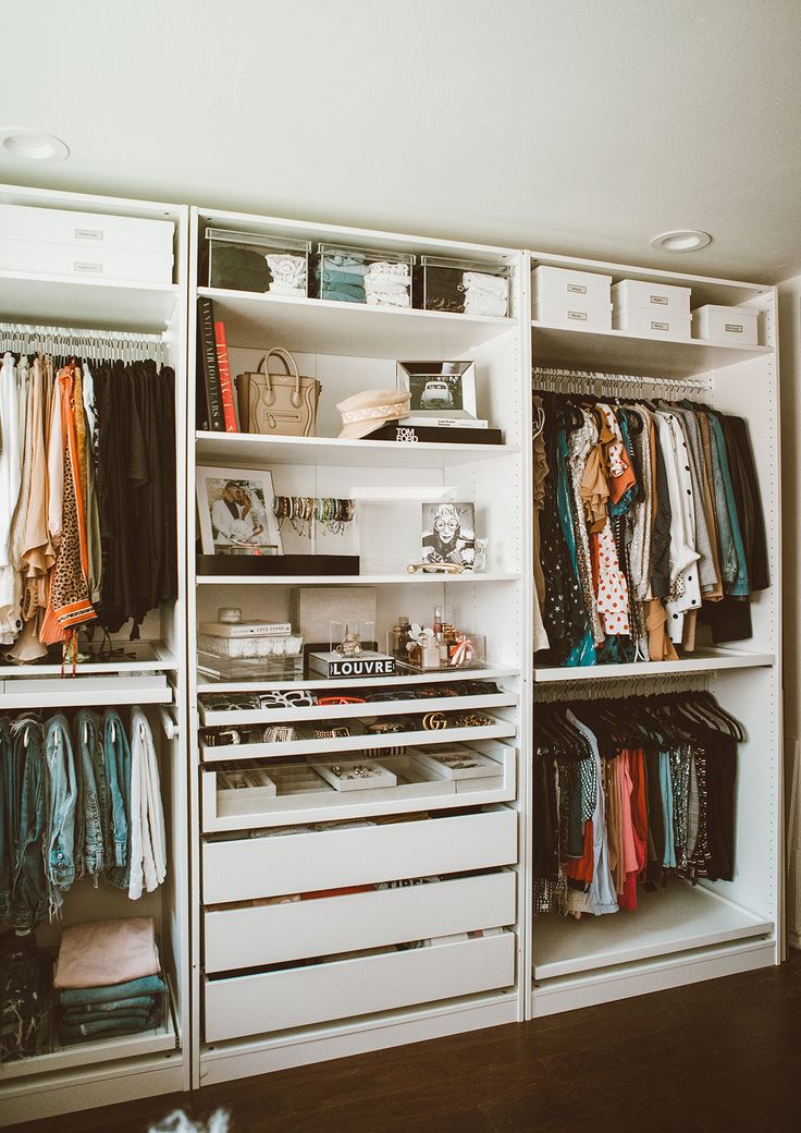 an organized closet with clothes and other items