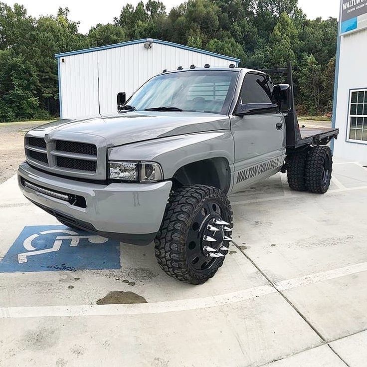 a silver truck parked in front of a building