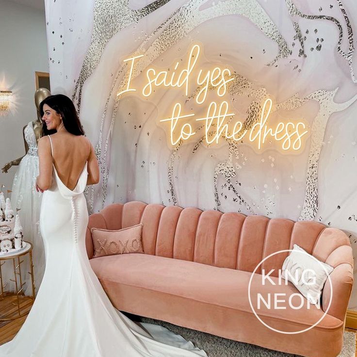 a woman standing in front of a couch with the words i said yes to the dress on it