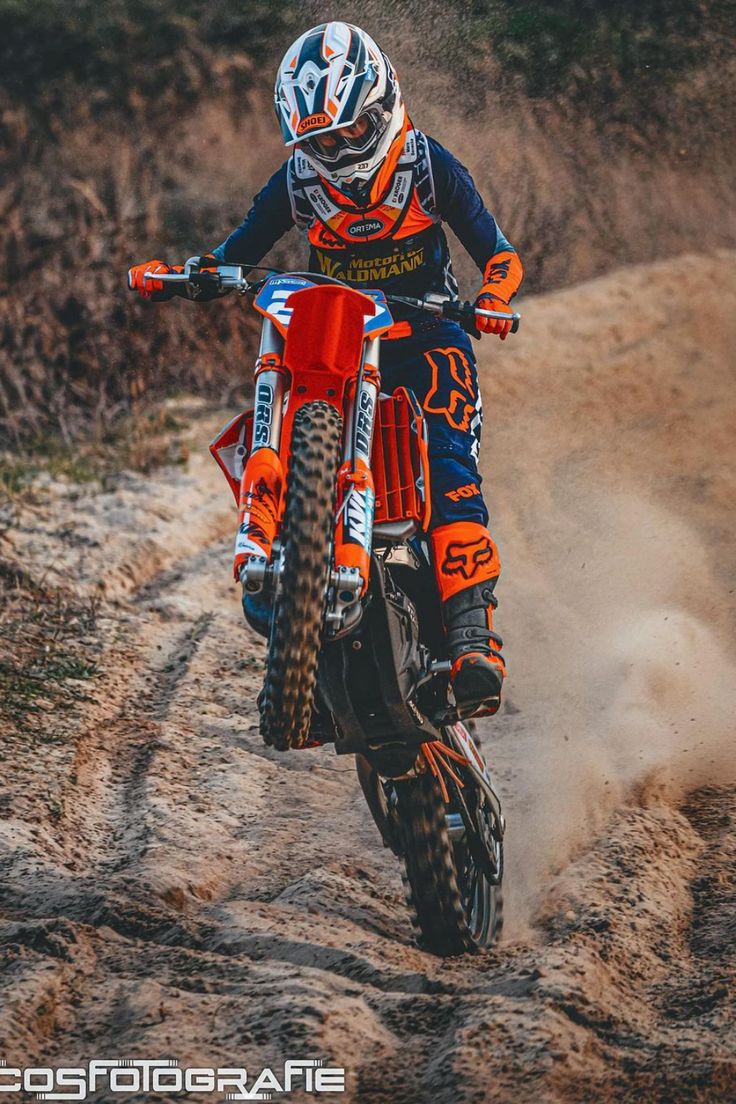 a man riding on the back of a dirt bike