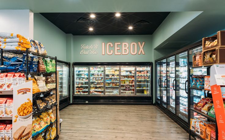 the inside of a grocery store filled with lots of food and drinks on display in glass cases