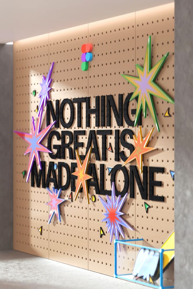 there is a sign that says nothing great is made alone on the wall next to it