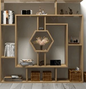 a book shelf filled with lots of books next to a wall mounted clock and lamp