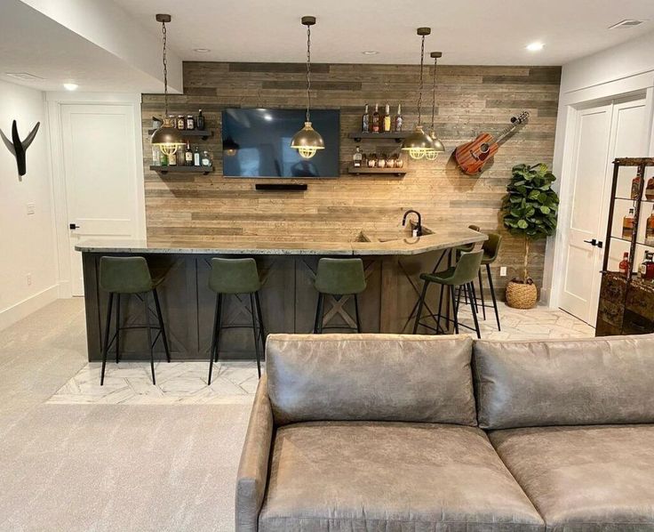 a living room filled with furniture and a bar