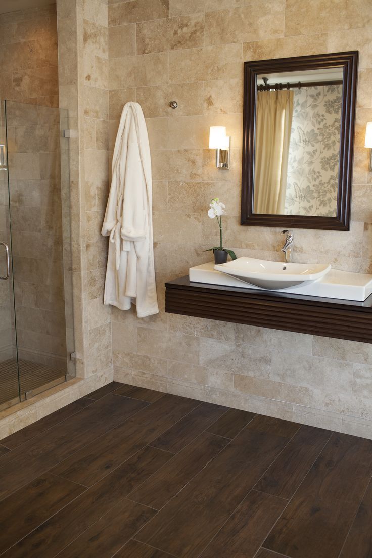 a bathroom with a sink, mirror and shower stall