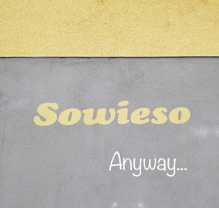 a yellow and gray sign that says soweiso on the side of a building