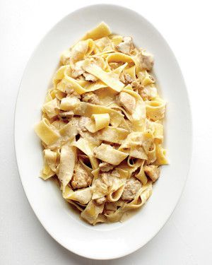 a white plate topped with pasta and meat