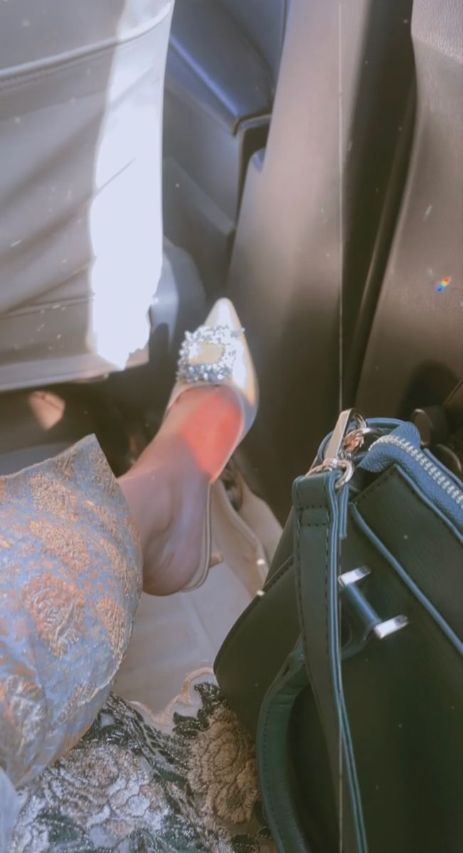 a woman's hand in her purse on the back seat of a car