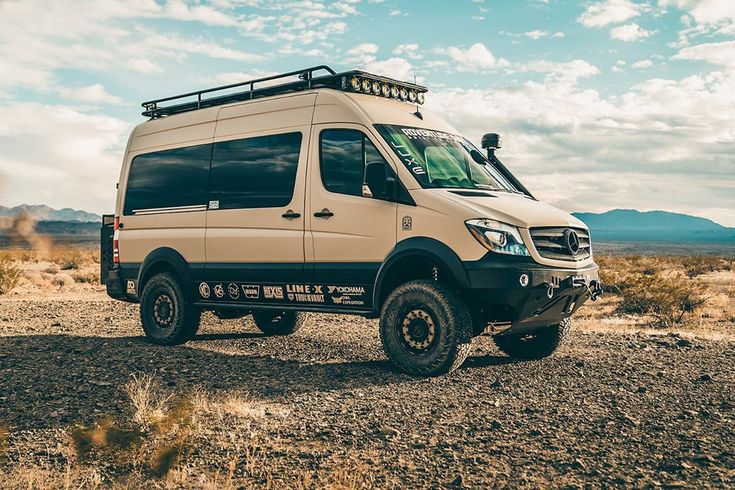 a white van parked in the middle of a desert