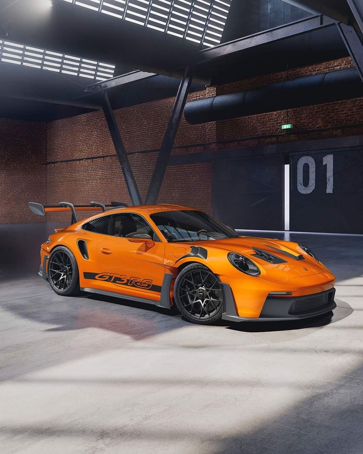 an orange sports car parked in a parking garage with the number 10 on it's side