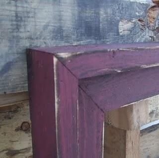 a cat is sitting on top of a purple shelf in the corner of a room