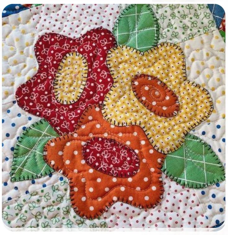 a close up of a flower on a quilted piece of cloth with polka dots