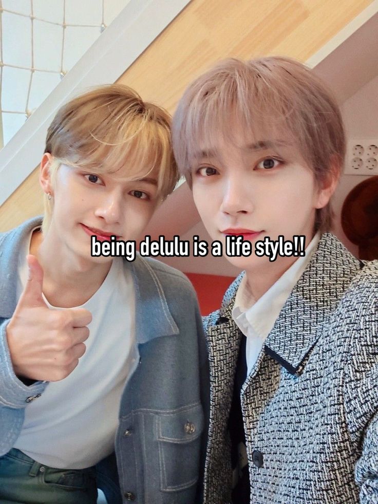 two young men giving thumbs up with the caption being delul is a life style