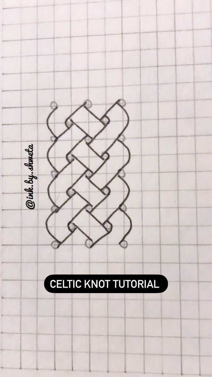 the celtic knot is drawn on top of a piece of paper