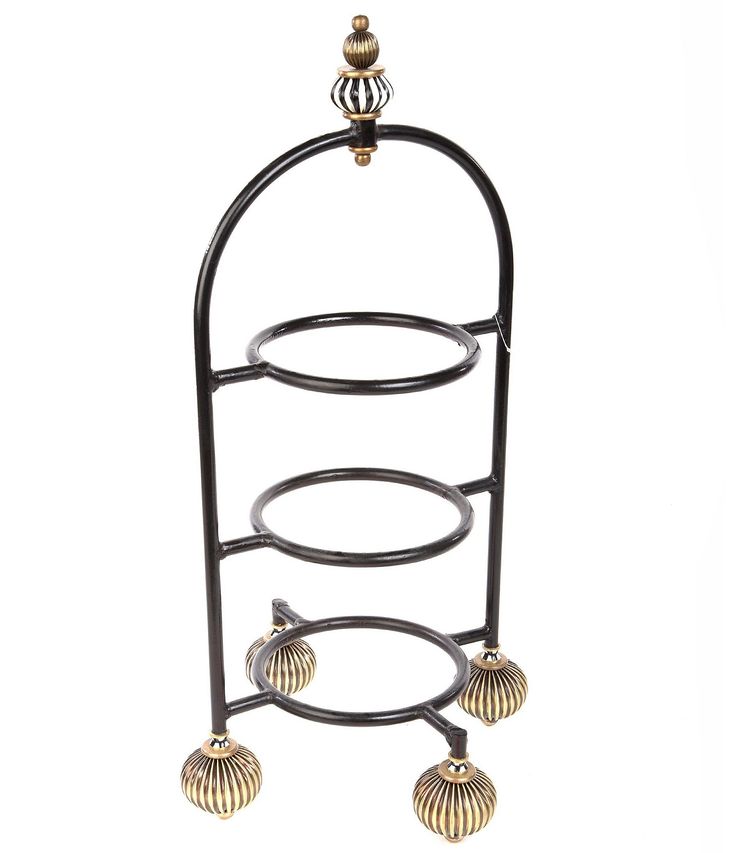 a metal rack with three circles and two balls on it's sides, hanging from the