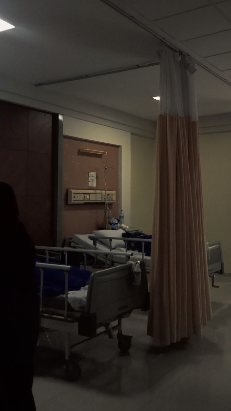 an empty hospital room with several beds in it