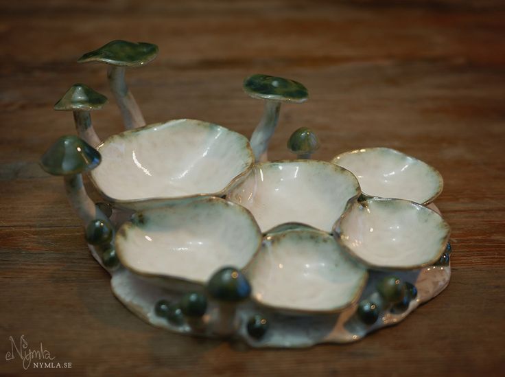 a group of small white bowls sitting on top of a wooden table