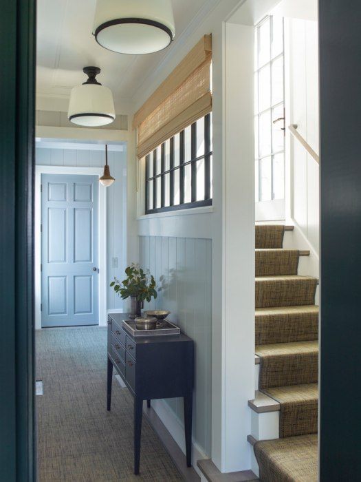 an entry way with stairs and a table