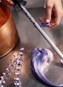 a person is using a brush to clean something on a table with other items in the background