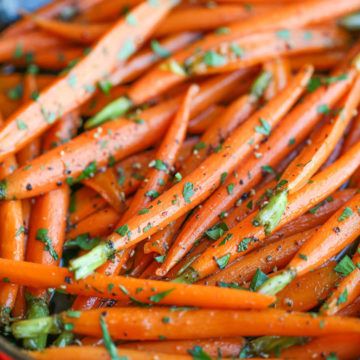 carrots with herbs and seasoning in a red bowl