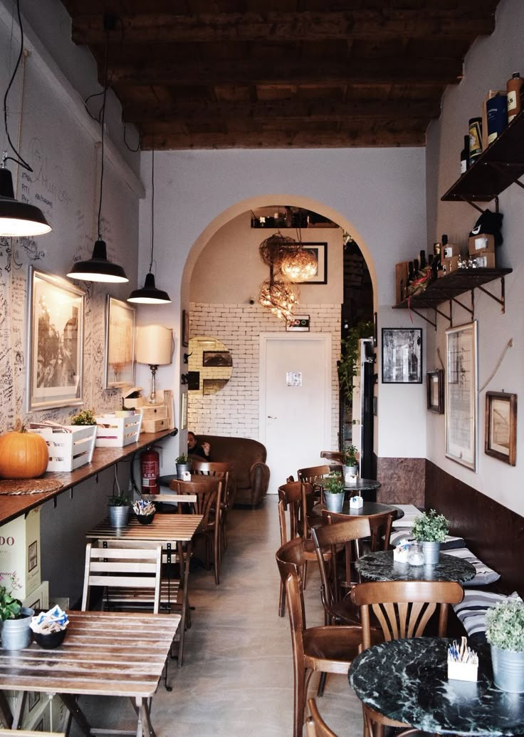 the inside of a restaurant with tables and chairs