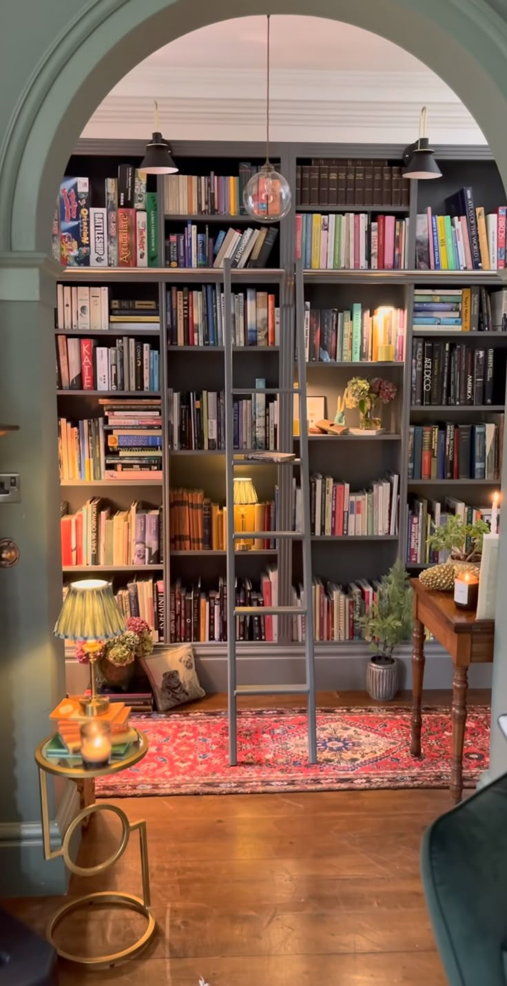 a living room filled with lots of books and furniture