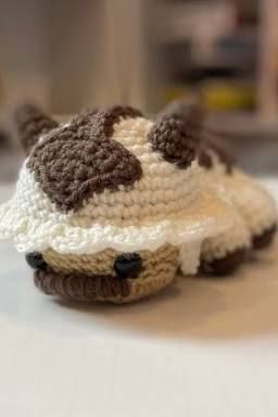 a small crocheted cow hat sitting on top of a table