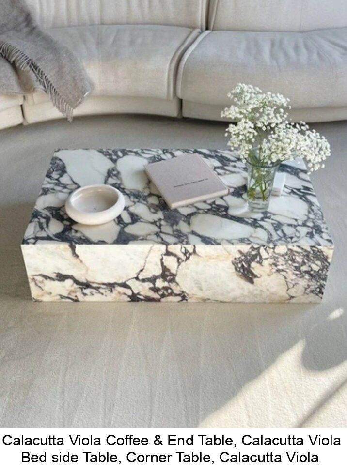 a marble coffee table sitting on top of a white couch