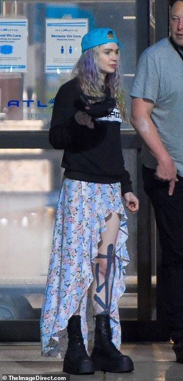 the man and woman are walking through an airport