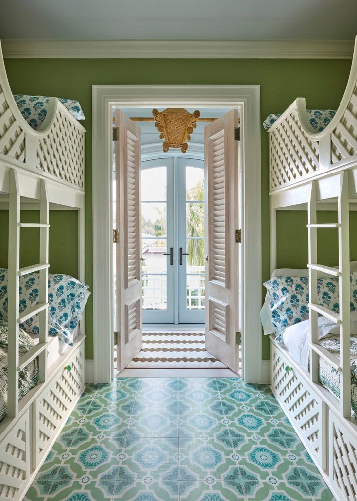 a room with bunk beds and green walls