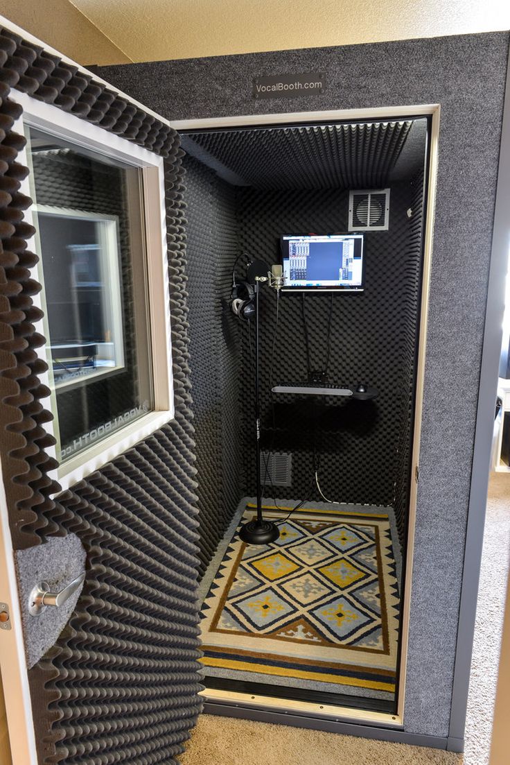 a bathroom with a mirror and tiled flooring in the shower area, next to a window