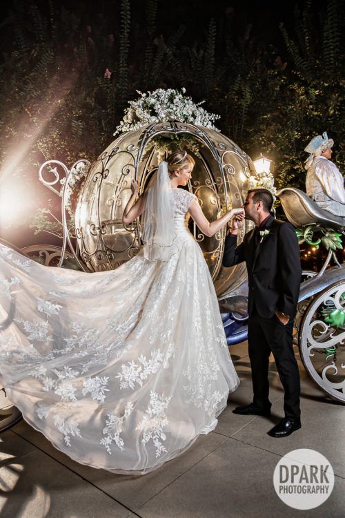 a bride and groom standing in front of a horse drawn carriage at their wedding reception