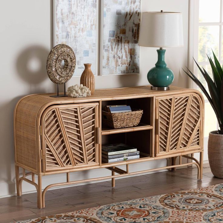 a living room with a rug, lamp and wicker sideboard