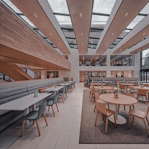 an empty restaurant with tables and chairs in the center, along with lots of windows