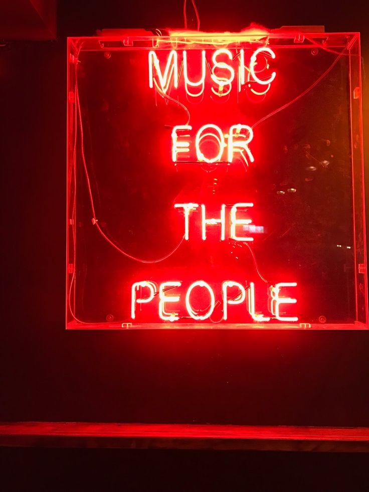 a neon sign that says music for the people