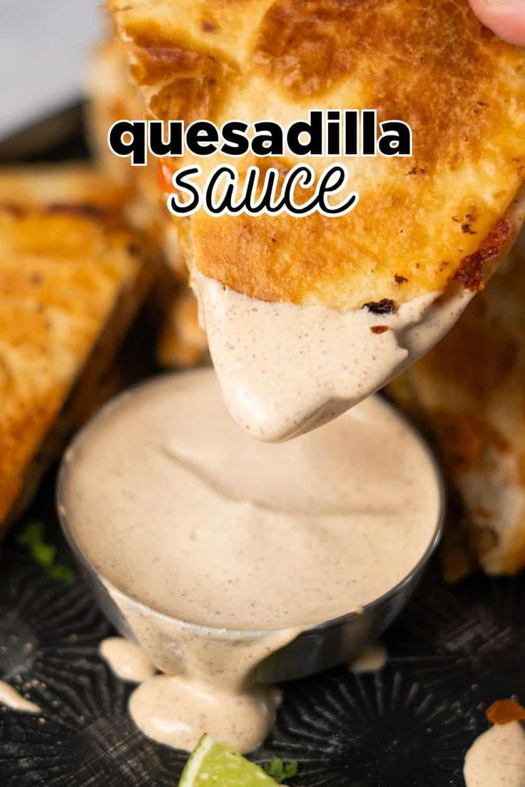 a piece of quesadilla sauce being held up to the camera with a spoon