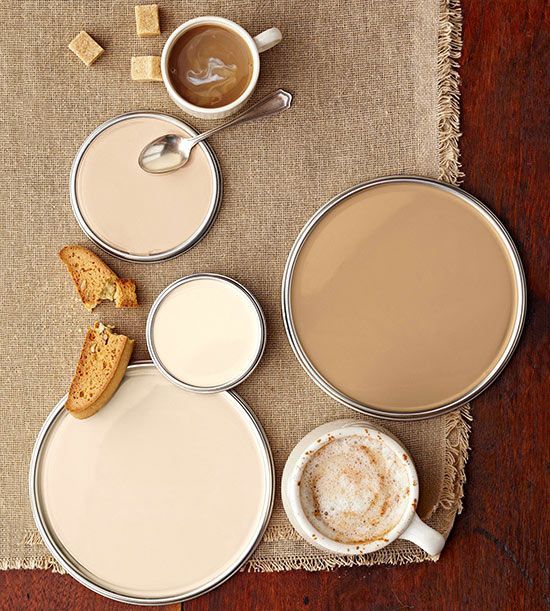 three cups of coffee and some bread on a table