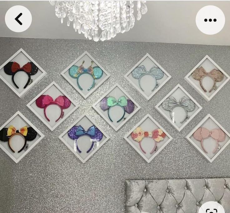 there are many minnie mouse ears hanging on the wall in this girls's bedroom