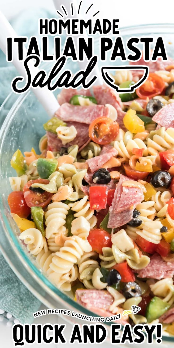 a pasta salad with ham and olives in a glass bowl