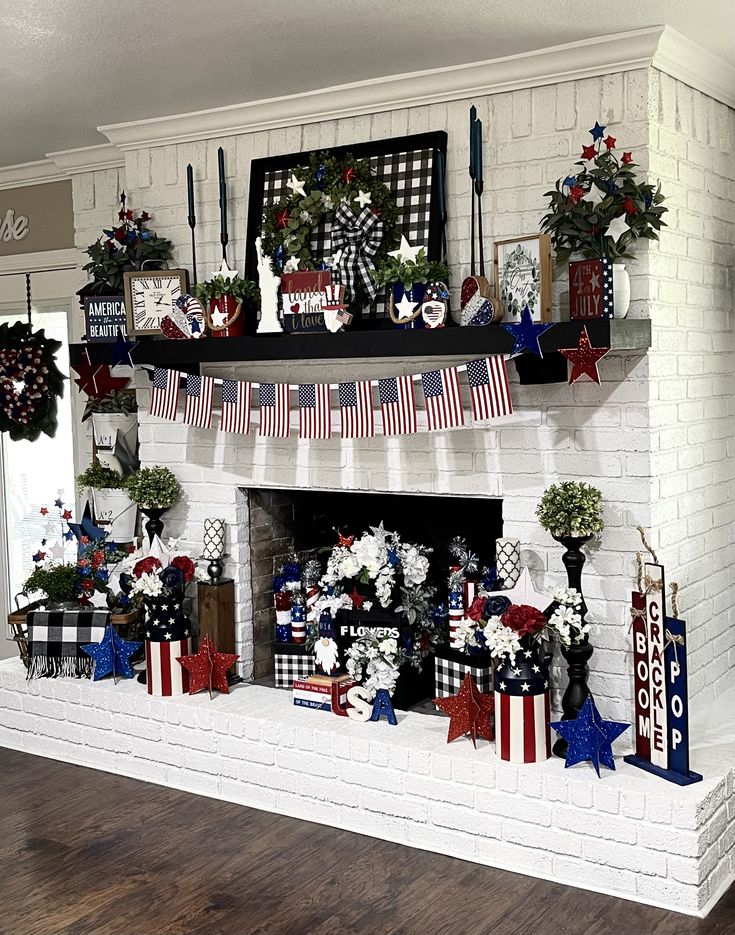 a fireplace decorated for the fourth of july with american flags and wreaths on it