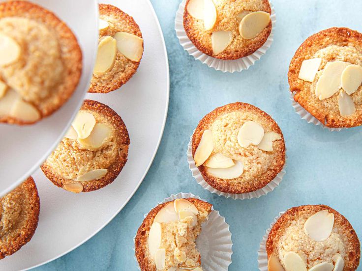 there are many muffins on the plate and one has been cut in half